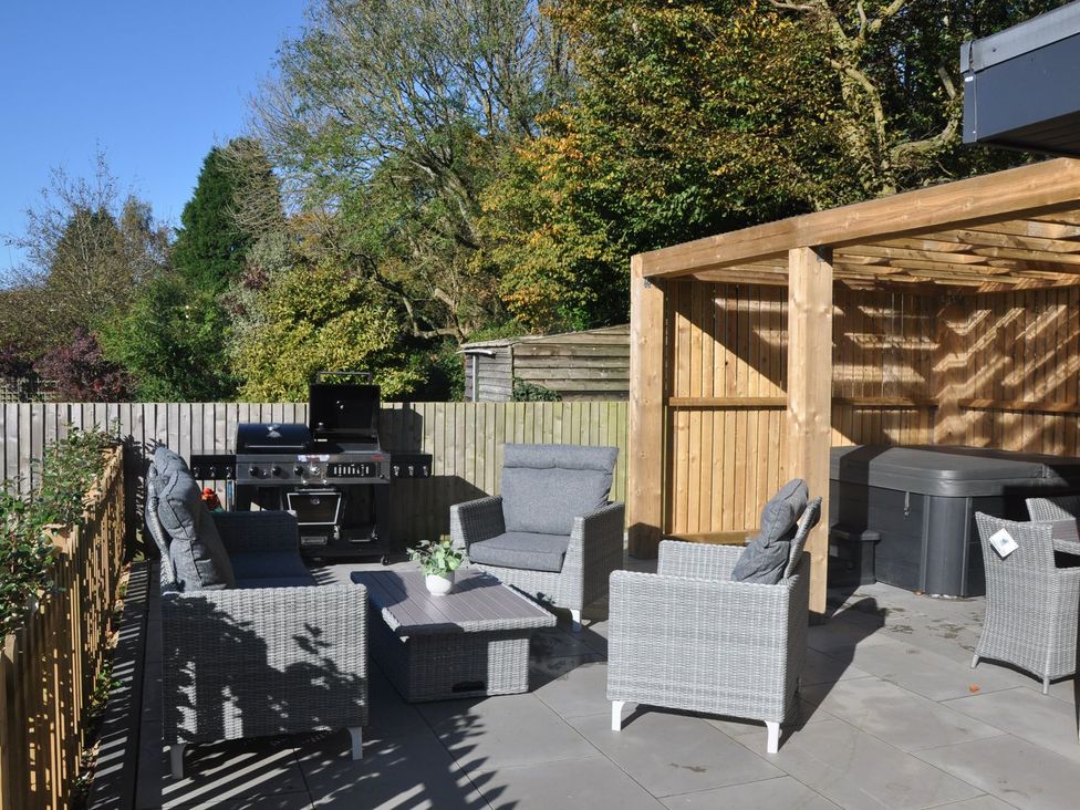 A patio area with outdoor furniture and a grill at Berisal in Ashford