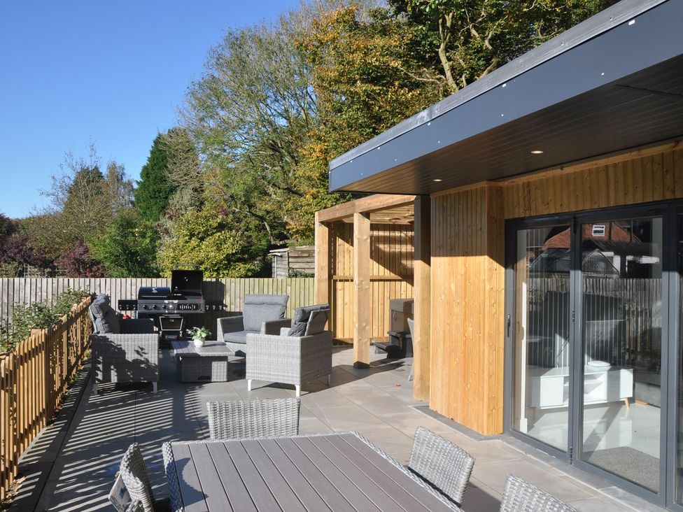 An outdoor space with furniture and a grill at Berisal in Ashford