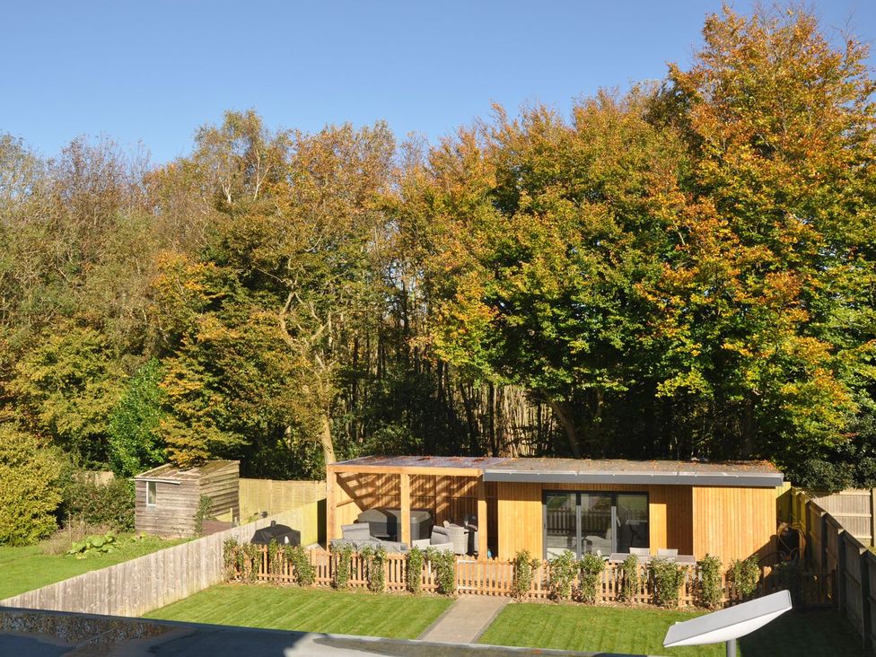 An outdoor area with a garden shed and seating at Berisal in Ashford