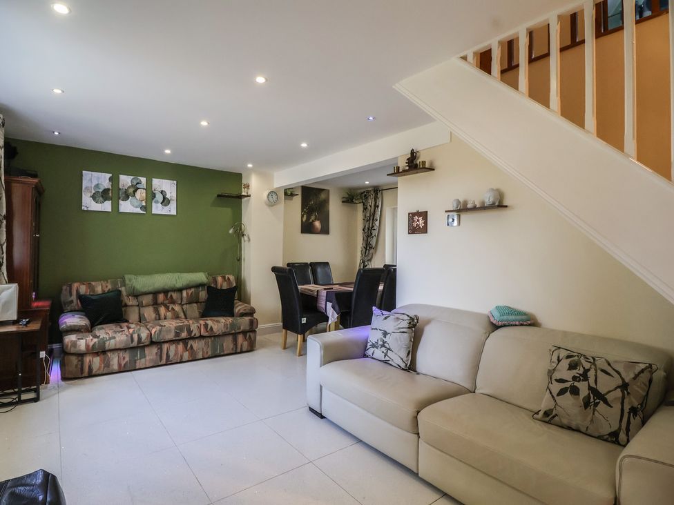 A living room with sofas and a dining area at 19 Hailey Road