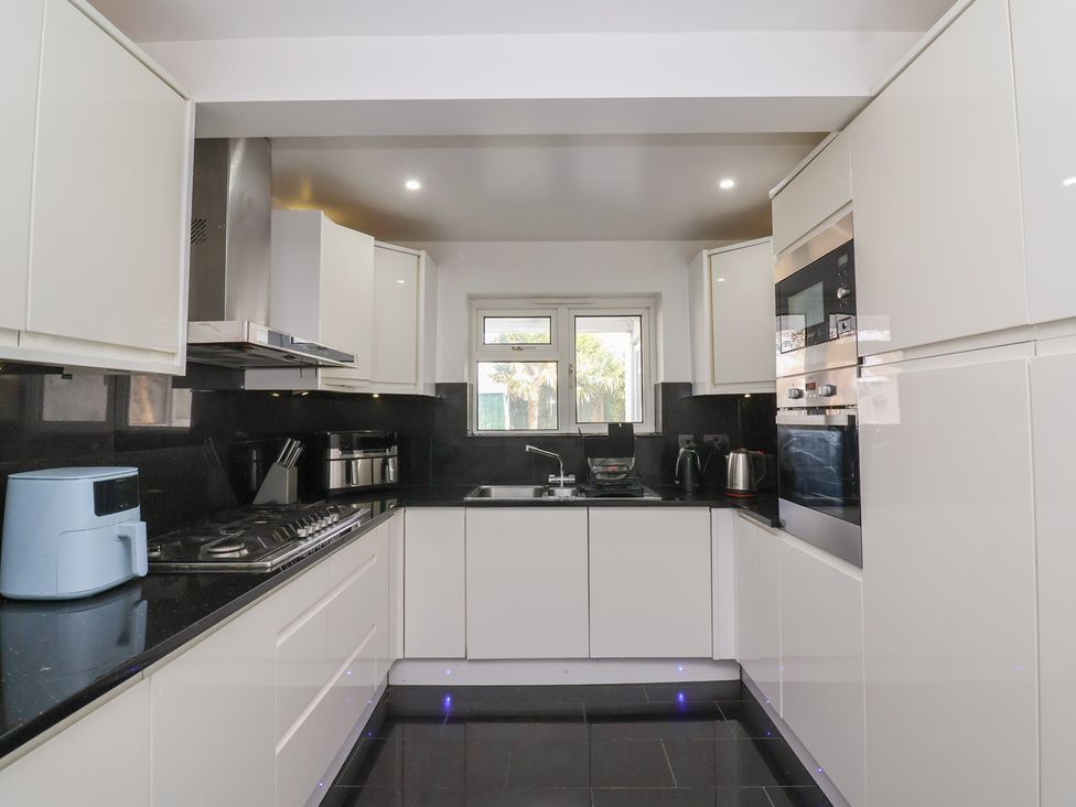 A kitchen with cabinets, sink, stove, and oven at 19 Hailey Road