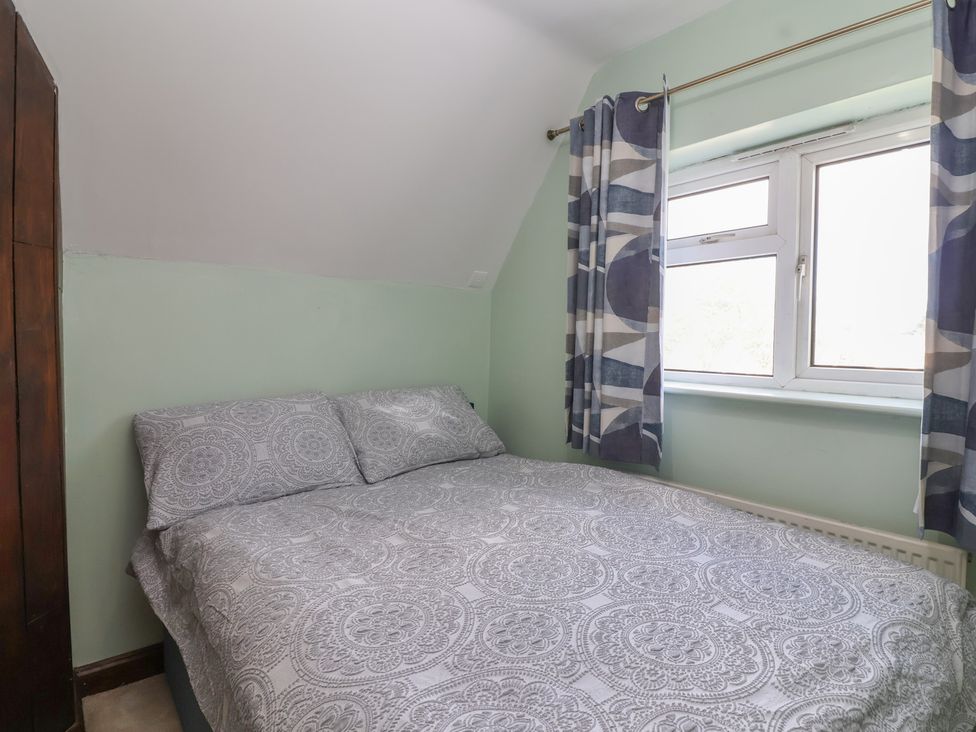 A bedroom with a bed and window at 19 Hailey Road