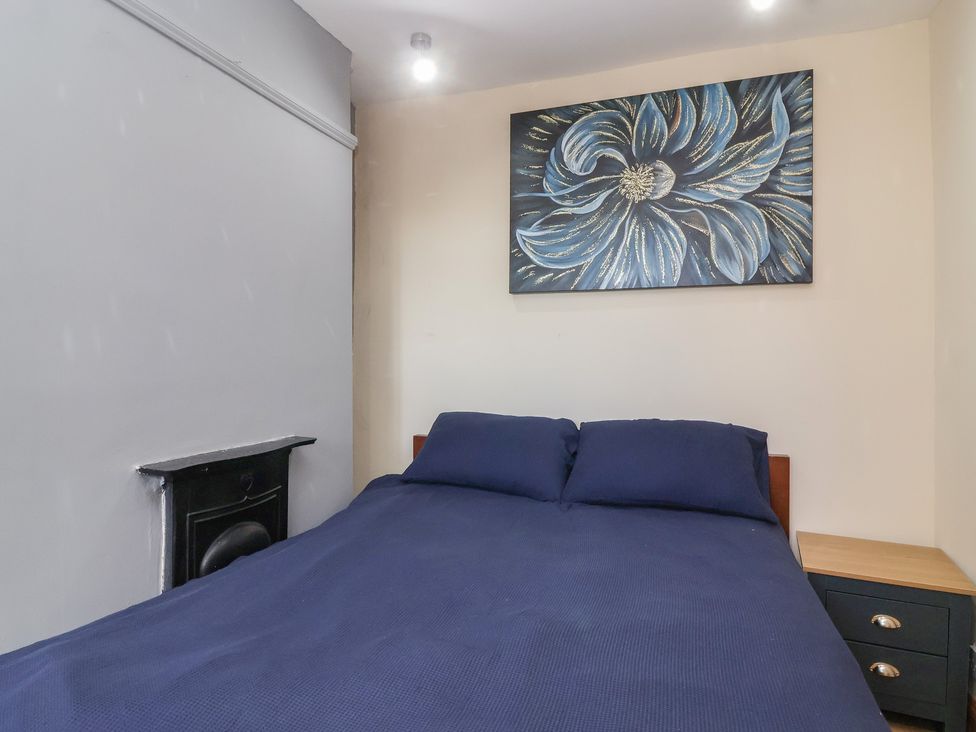A bedroom with a bed and nightstand at 19 Hailey Road