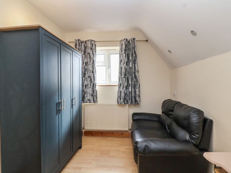 A living room with a wardrobe and sofa at 19 Hailey Road