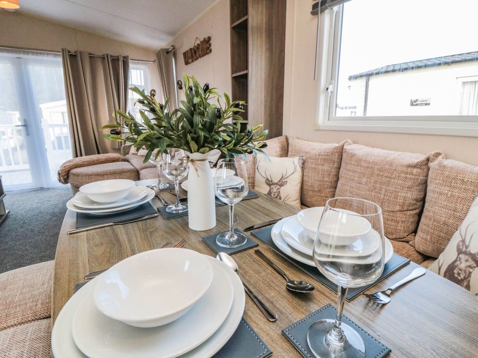A dining area with a table set for meals at Gosling 14 in Scarborough