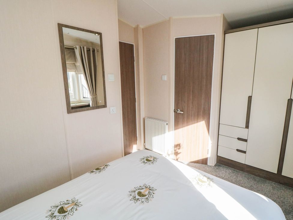 A bedroom with a bed and wardrobe at Gosling 14 in Scarborough