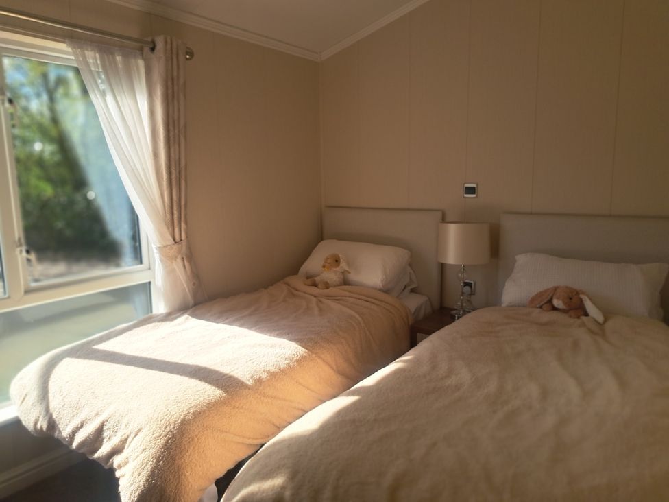 A bedroom with two beds and a lamp at Chapel Farm Static Caravan Holiday Park Lucky Lodge 7 Appleby-in-Westmorland