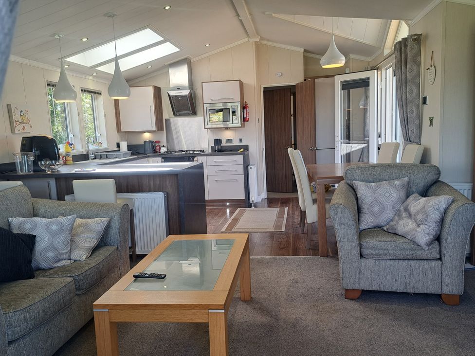 A living room with a sofa and dining area at Chapel Farm Static Caravan Holiday Park Lucky Lodge 7 Appleby-in-Westmorland