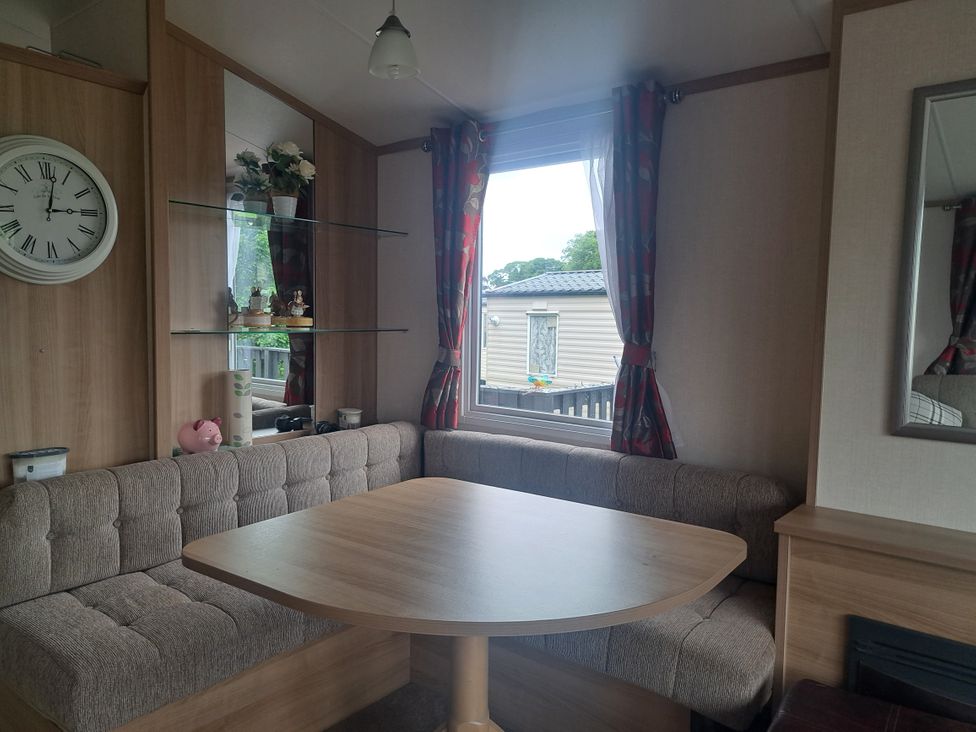 A dining area with a table and sofa seating at Chapel Farm Static Caravan Holiday Park Pennine Views No 17 Appleby-in-Westmorland