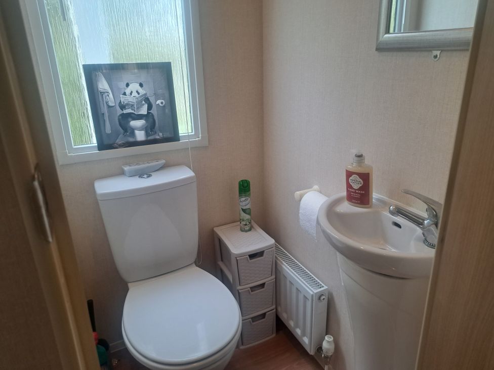 A bathroom with a toilet and a sink at Chapel Farm Static Caravan Holiday Park Pennine Views No 17 Appleby-in-Westmorland
