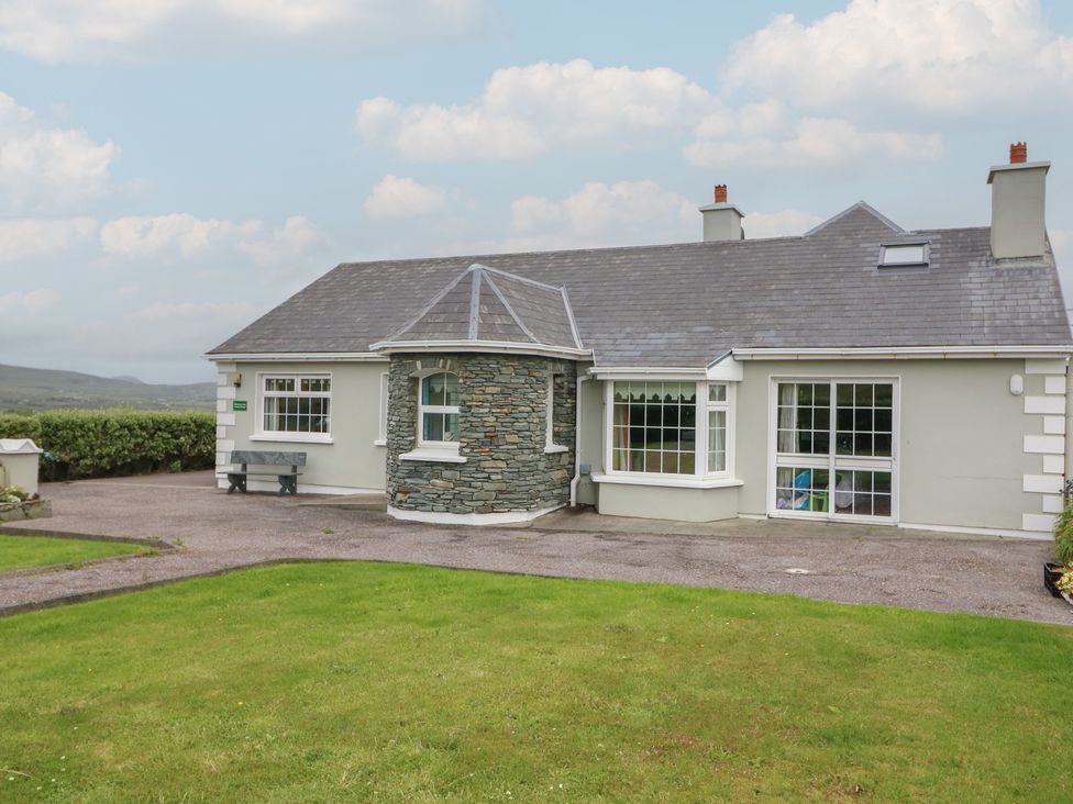 A house with stone feature and garden at Wild Atlantic Way Country Cottage in Portmagee, County Kerry