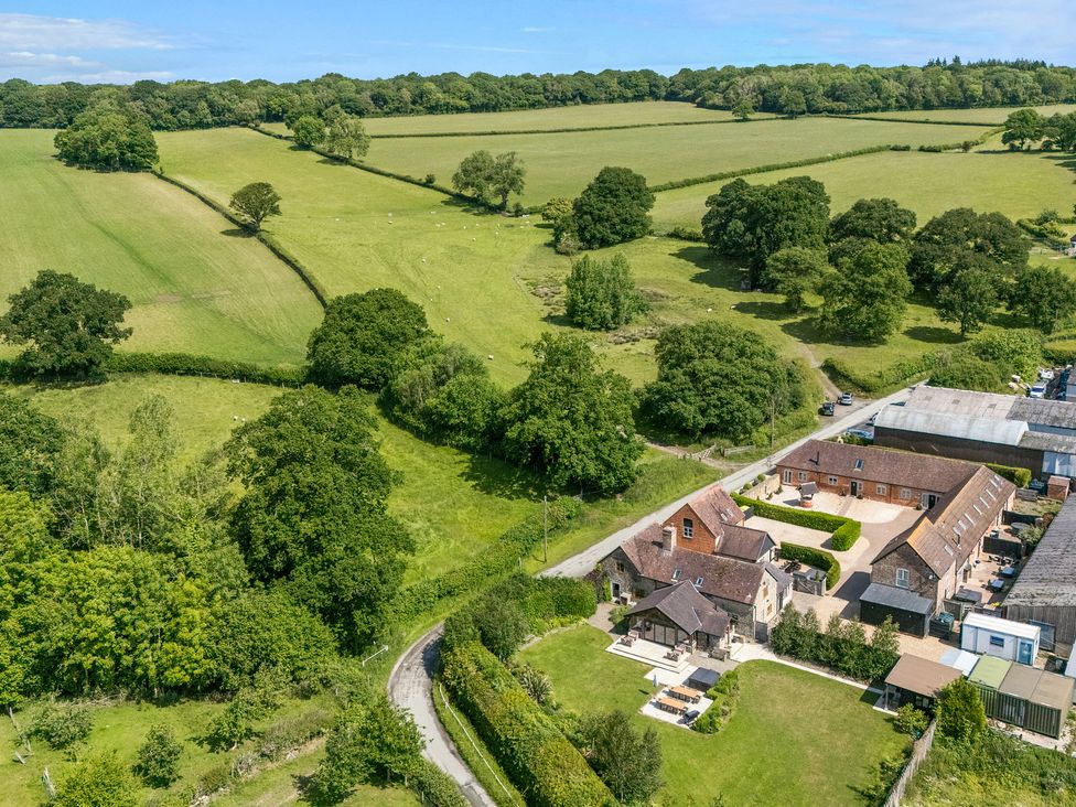 An outdoor view of fields and cottages at The Turnip House in Westhope