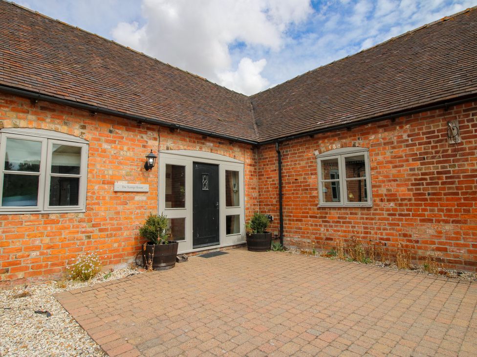 An exterior view of a house with brick wall and front door at The Turnip House in Westhope