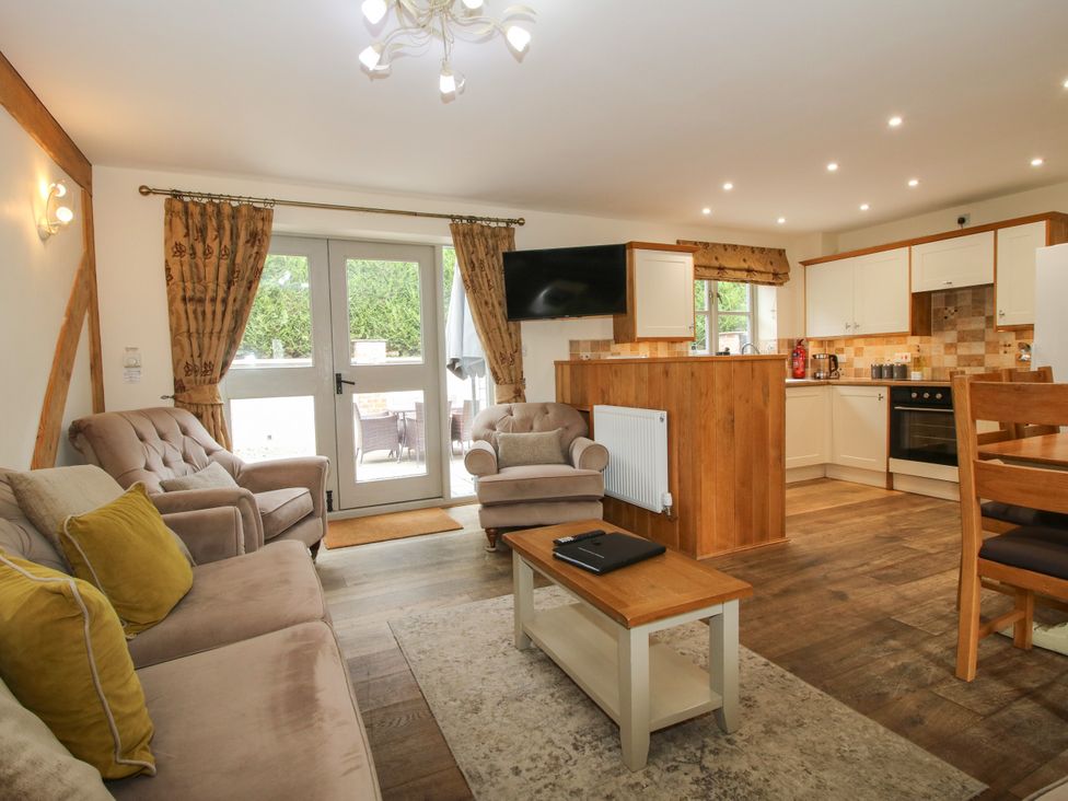 A living room with a sofa and dining area at The Turnip House in Westhope
