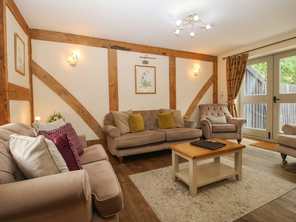 A living room with sofas, a coffee table and artwork at The Turnip House in Westhope