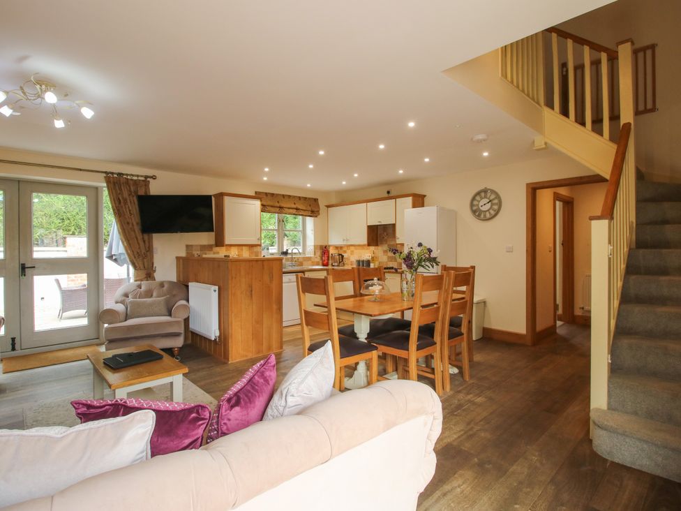 A living room with a dining area and kitchen at The Turnip House in Westhope