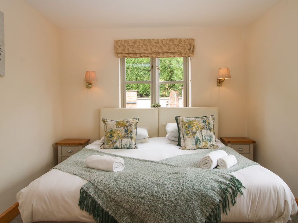 A bedroom with a double bed and bedside tables at The Turnip House in Westhope