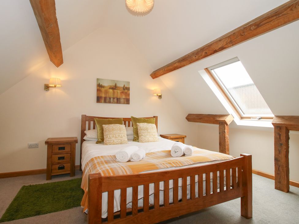 A bedroom with a bed and two bedside tables at The Turnip House in Westhope