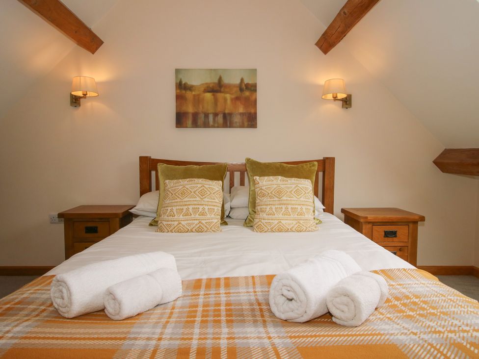 A bedroom with a bed and bedside tables at The Turnip House in Westhope