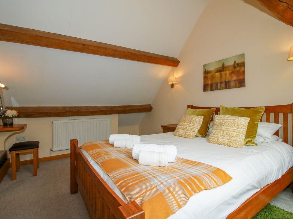 A bedroom with a double bed and desk at The Turnip House in Westhope
