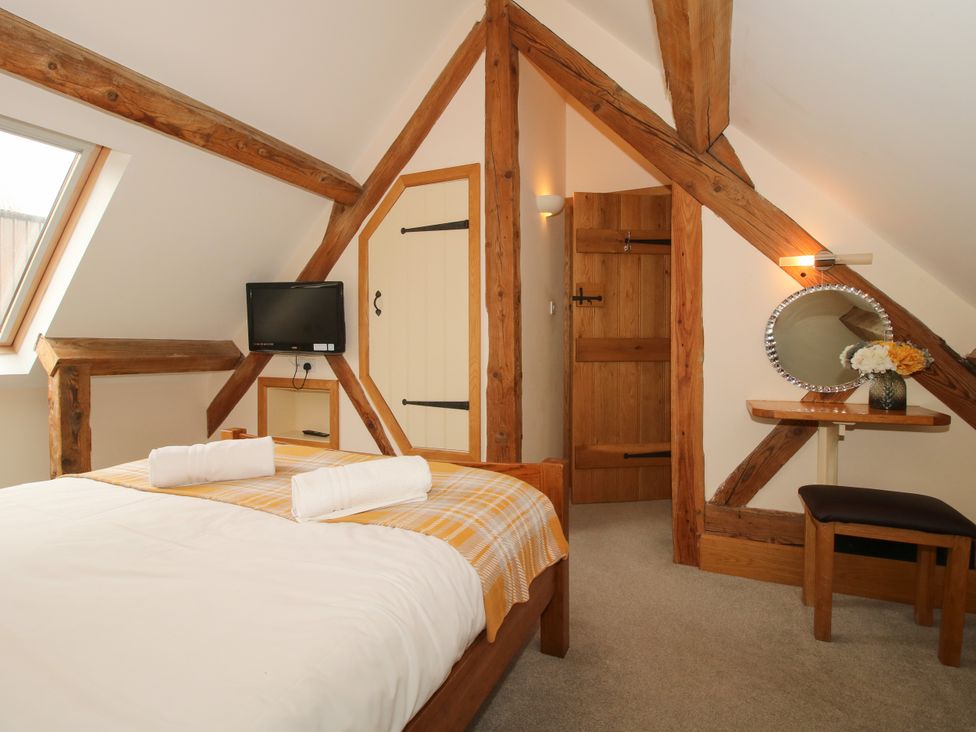 A bedroom with a bed and a television at The Turnip House in Westhope
