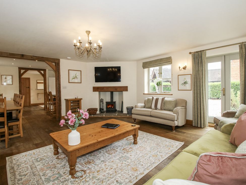 A living room with a sofa and television at The Milking Parlour in Westhope