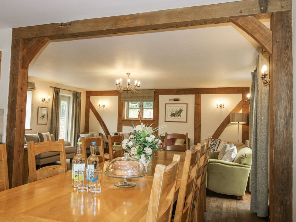 A dining room with a large table and chairs at The Milking Parlour in Westhope