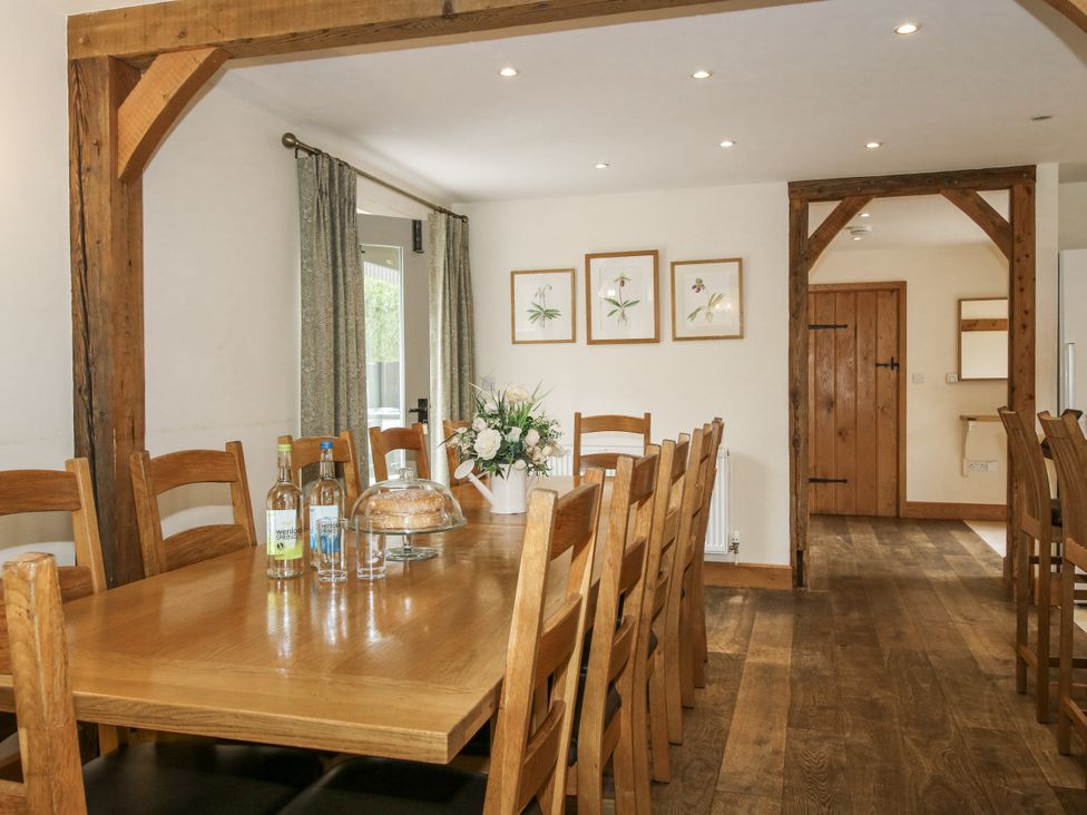 A dining room with a large table and chairs at The Milking Parlour in Westhope