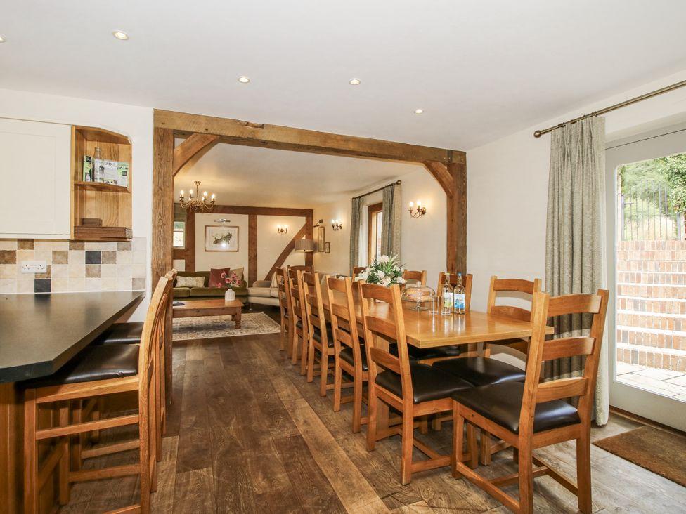 A dining room with a long table and chairs at The Milking Parlour in Westhope