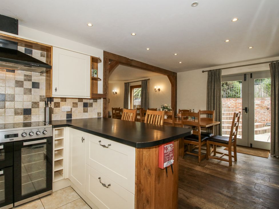 A kitchen with stove and seating area at The Milking Parlour in Westhope