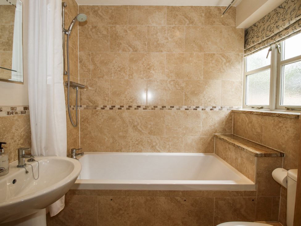A bathroom with a bathtub and sink at The Milking Parlour in Westhope