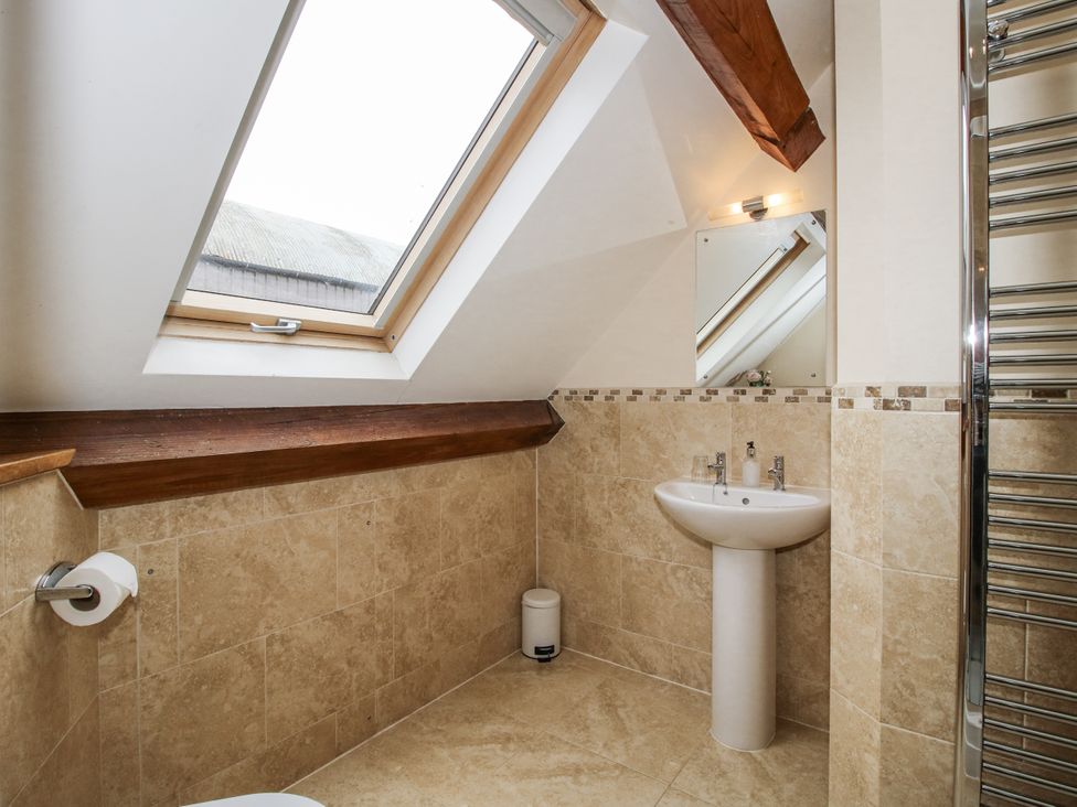A bathroom with a sink and towel radiator at The Milking Parlour in Westhope