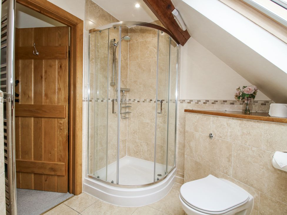 A bathroom with a shower and toilet at The Milking Parlour in Westhope