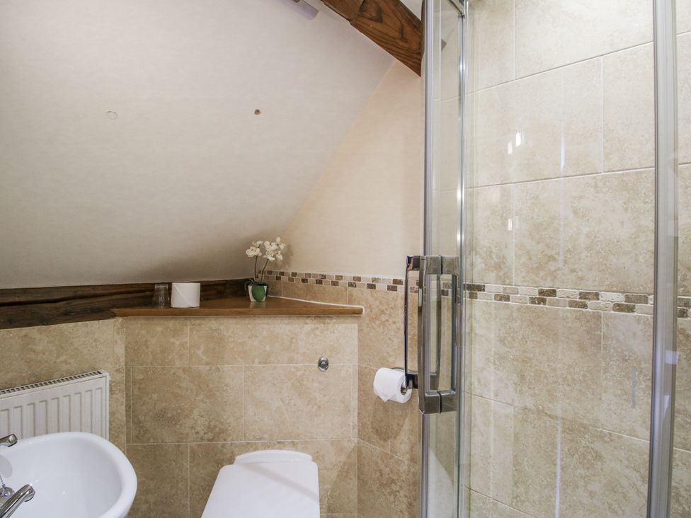 A bathroom with a shower and sink at The Milking Parlour in Westhope