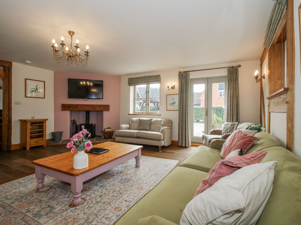 A living room with seating and television at The Milking Parlour in Westhope