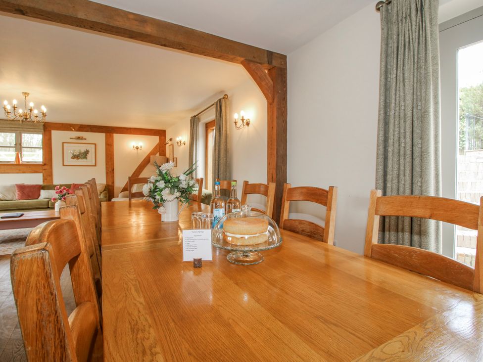 A dining room with a long table and chairs at The Milking Parlour in Westhope