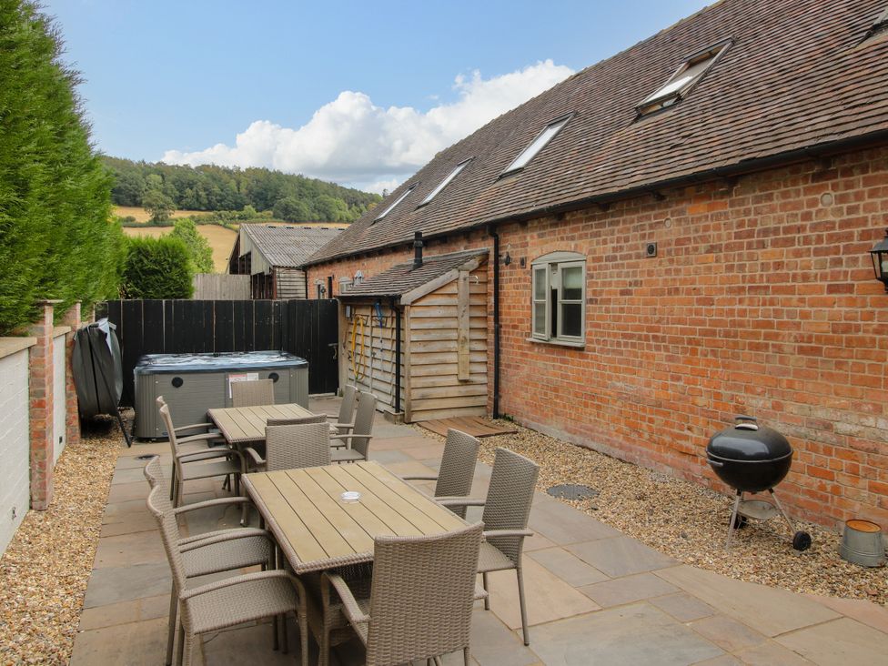 An outdoor dining area with a table and chairs at The Milking Parlour in Westhope
