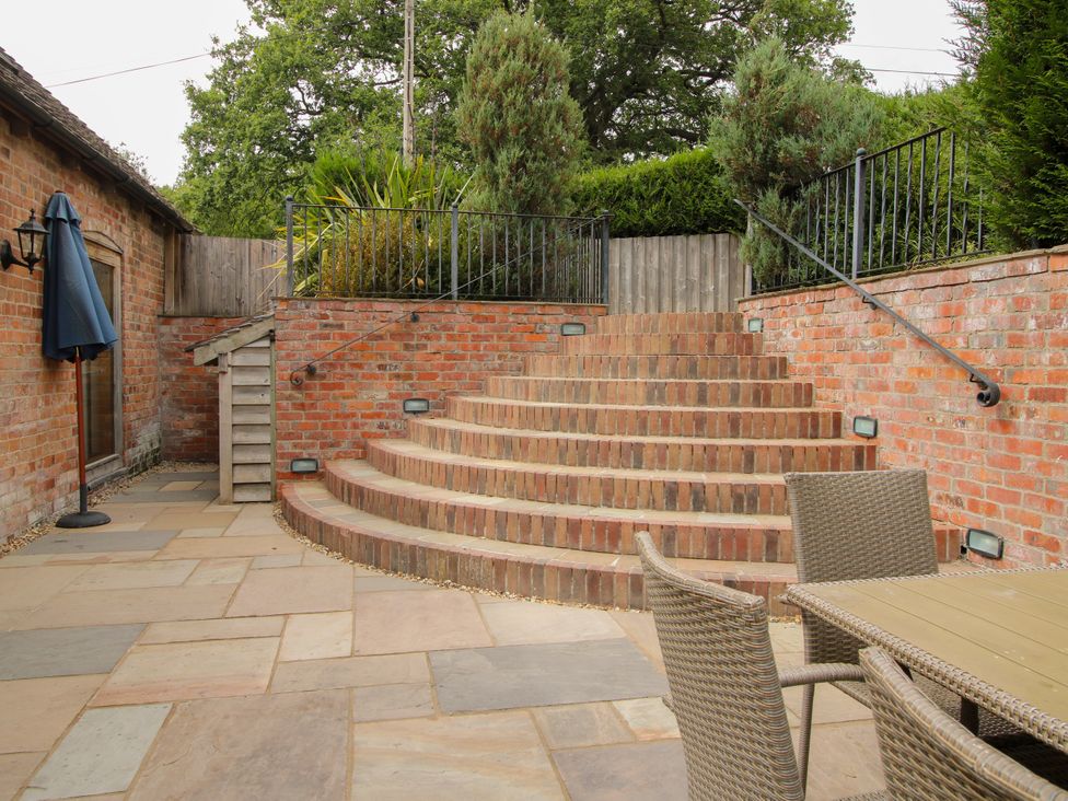 A garden with stairs and seating area at The Milking Parlour in Westhope