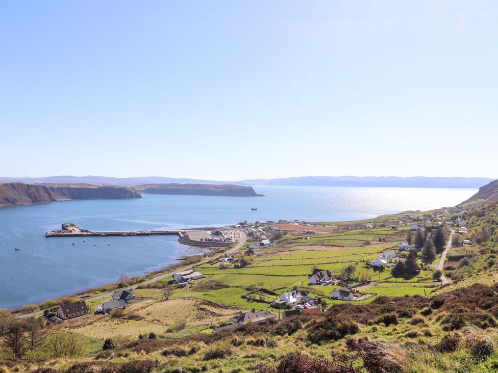 A coastal view of a harbor and village at Jubilee Cottage Uig