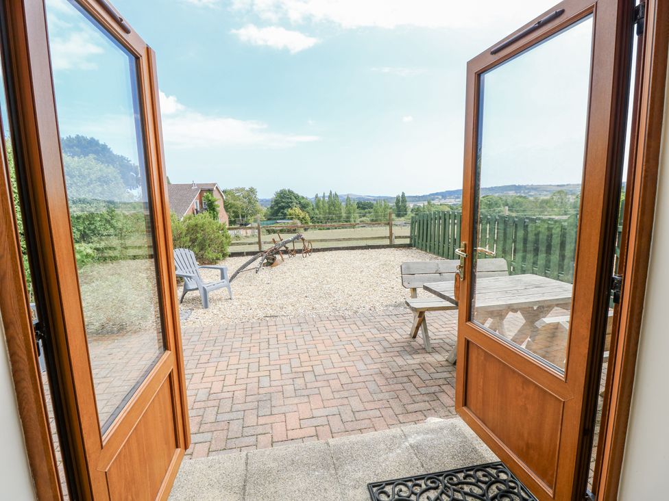 A patio area with a table and seating at 2 The Stables in Ryde