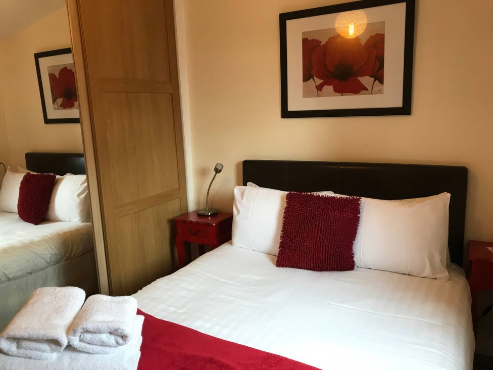 A bedroom with a bed and a bedside table at Primrose Lodge in Saltburn-by-the-Sea