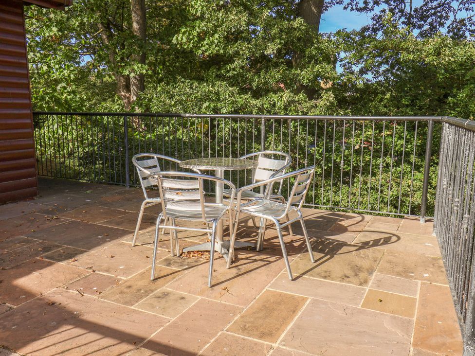 A table and chairs on an outdoor terrace at Primrose Lodge in Saltburn-by-the-Sea