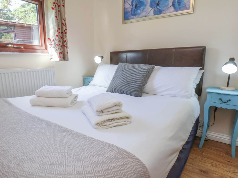 A bedroom with a bed and bedside tables at Primrose Lodge in Saltburn-by-the-Sea