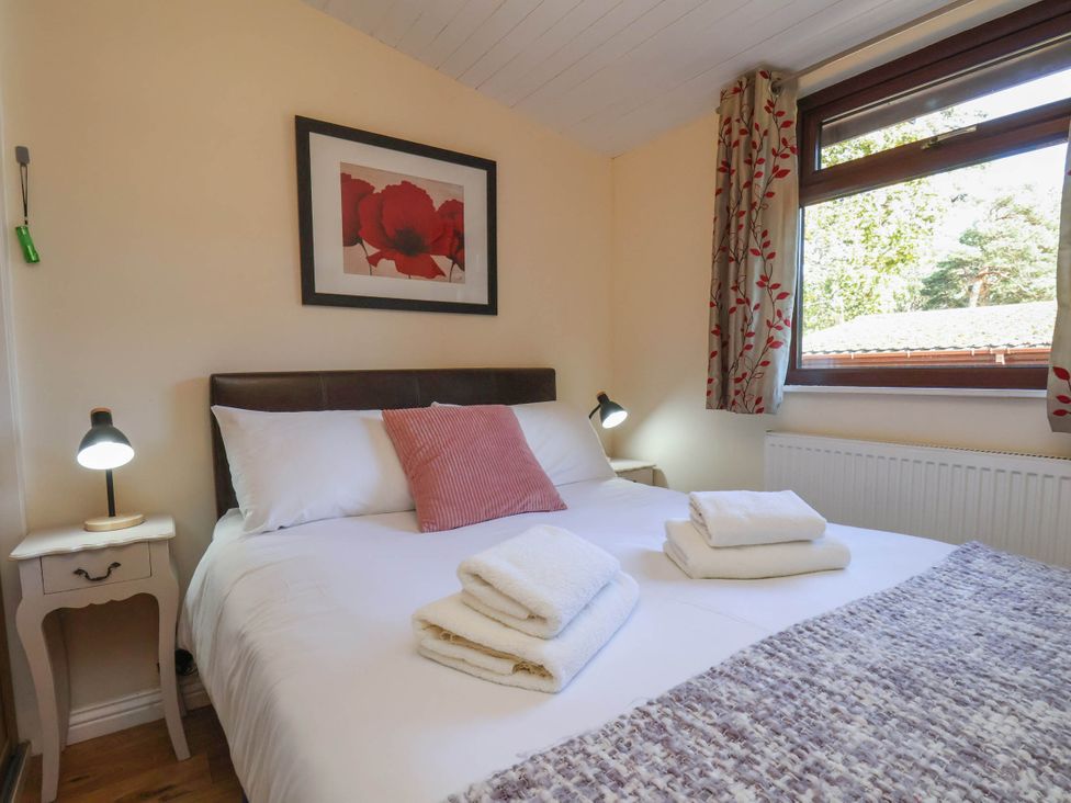 A bedroom with a double bed and bedside table at Primrose Lodge in Saltburn-by-the-Sea
