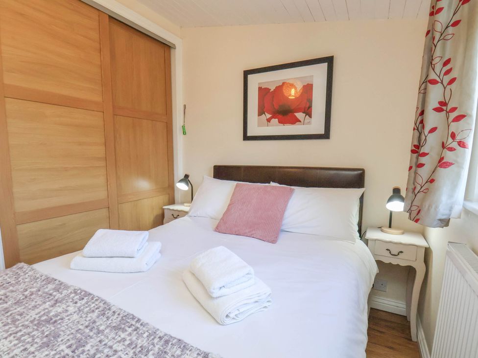 A bedroom with a double bed and side tables at Primrose Lodge Saltburn-by-the-Sea