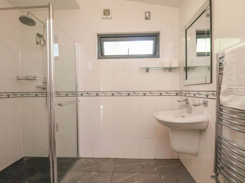 A bathroom with a shower and sink at Primrose Lodge in Saltburn-by-the-Sea