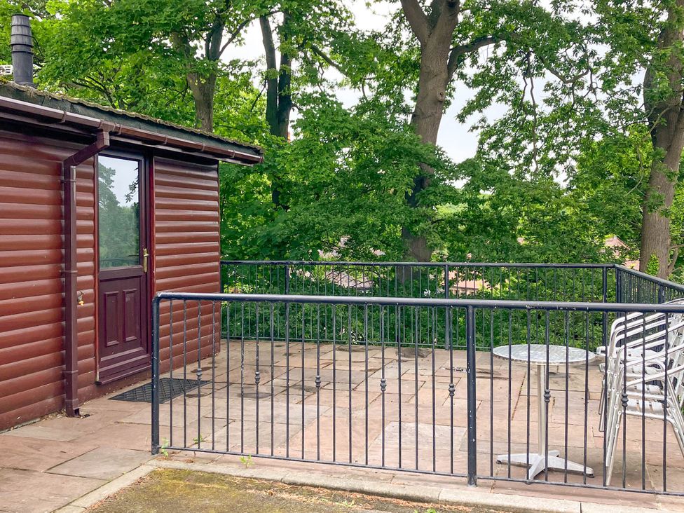 An outdoor patio with a table and chairs at Primrose Lodge Saltburn-by-the-Sea