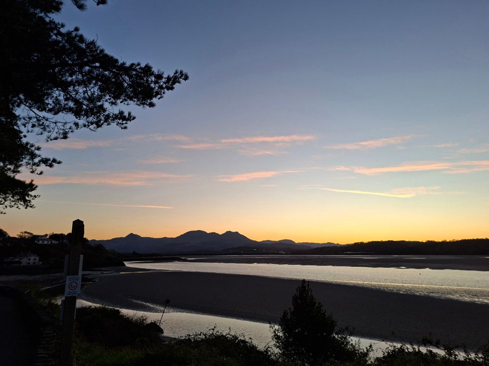 A view of mountains and water at sunset at Llannor in Borth-y-Gest