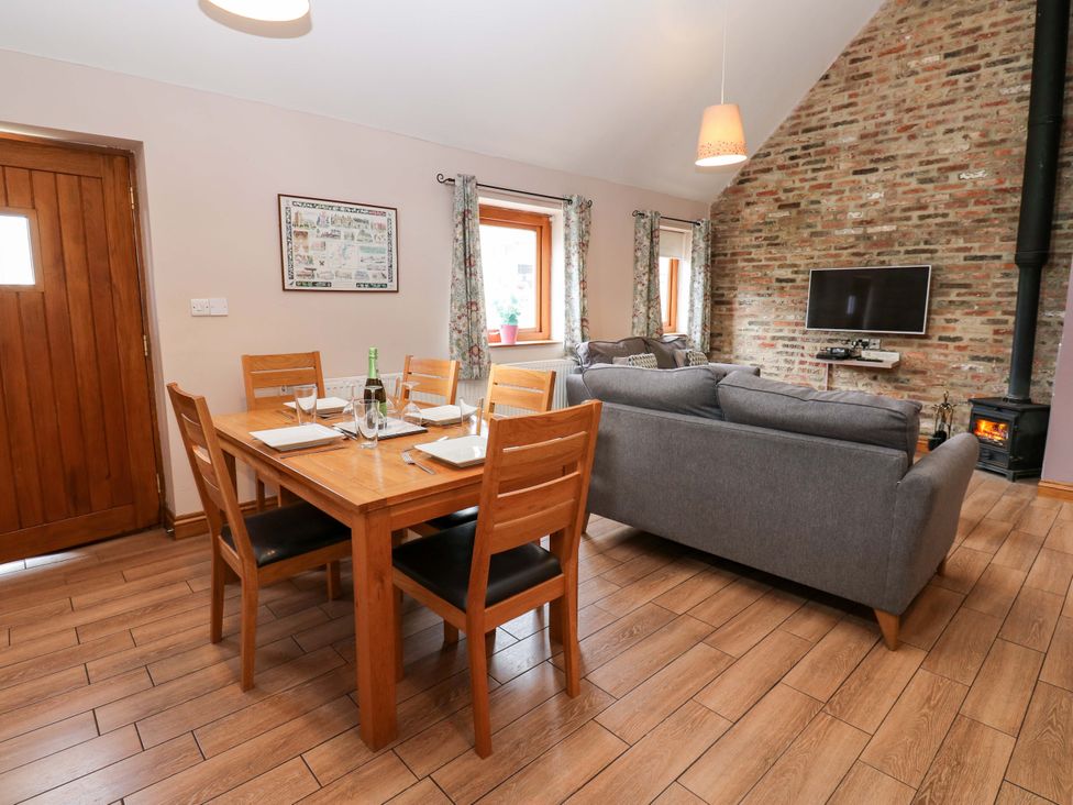 A dining room with a table and chairs at Pottowe Cottage in Potto near Stokesley
