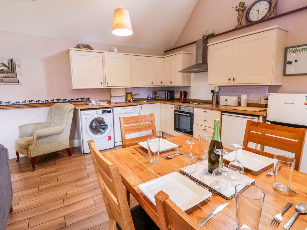A kitchen with a dining table set at Pottowe Cottage in Potto near Stokesley